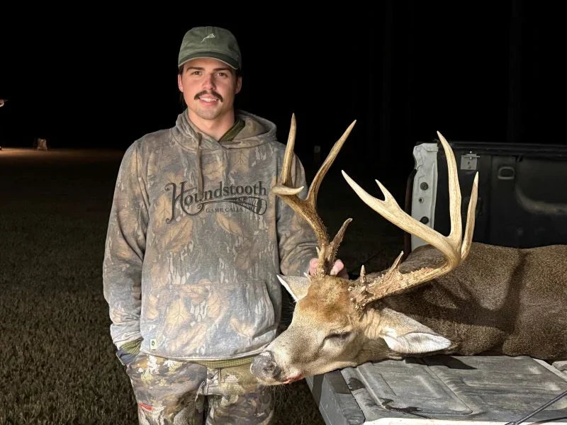 Drake from Houndstooth Game Calls poses with his trophy buck