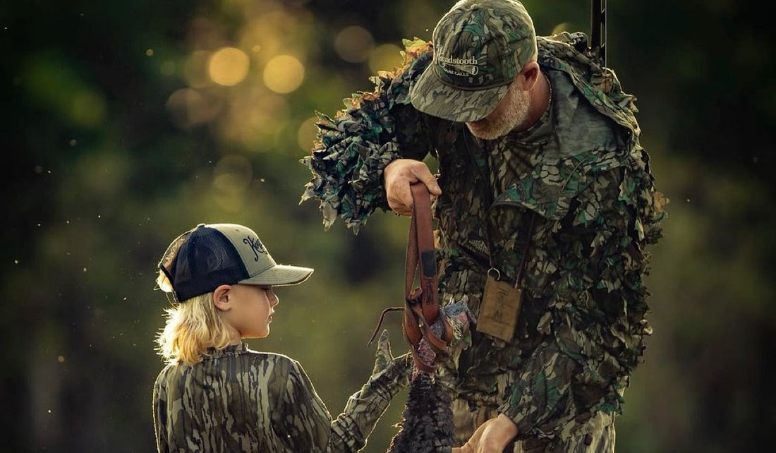 a hunter and his child carrying a turkey out after a successful hunt