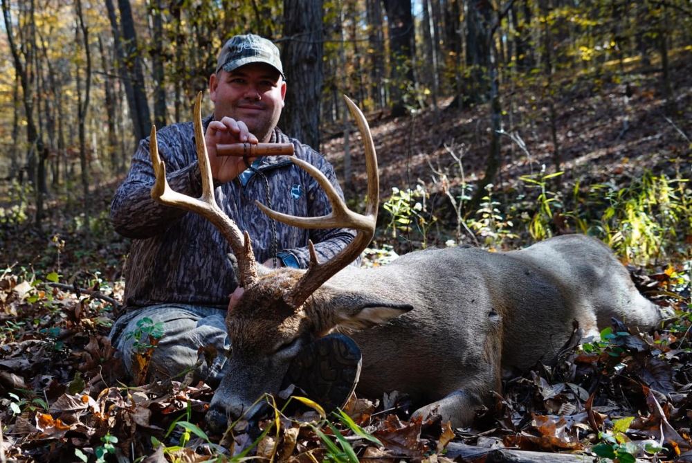 hunter with a buck and his handmade in the USA deer grunt call
